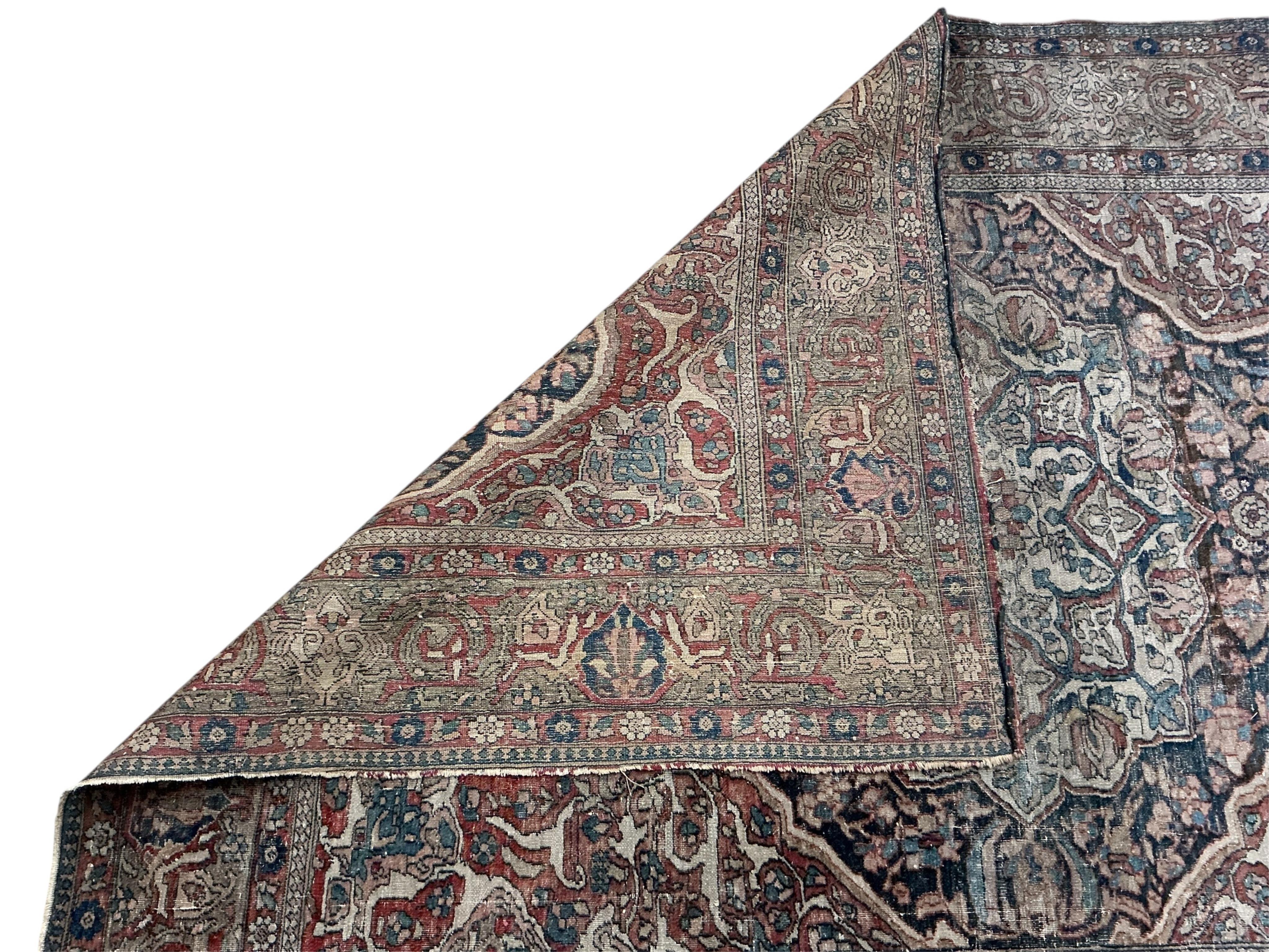 Two antique Isphahan rugs, (worn), larger 194 x 138cm
